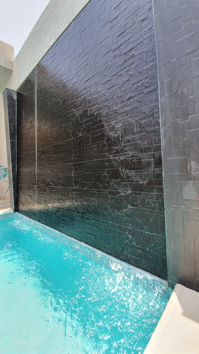 Water wall flowing into a rest house pool