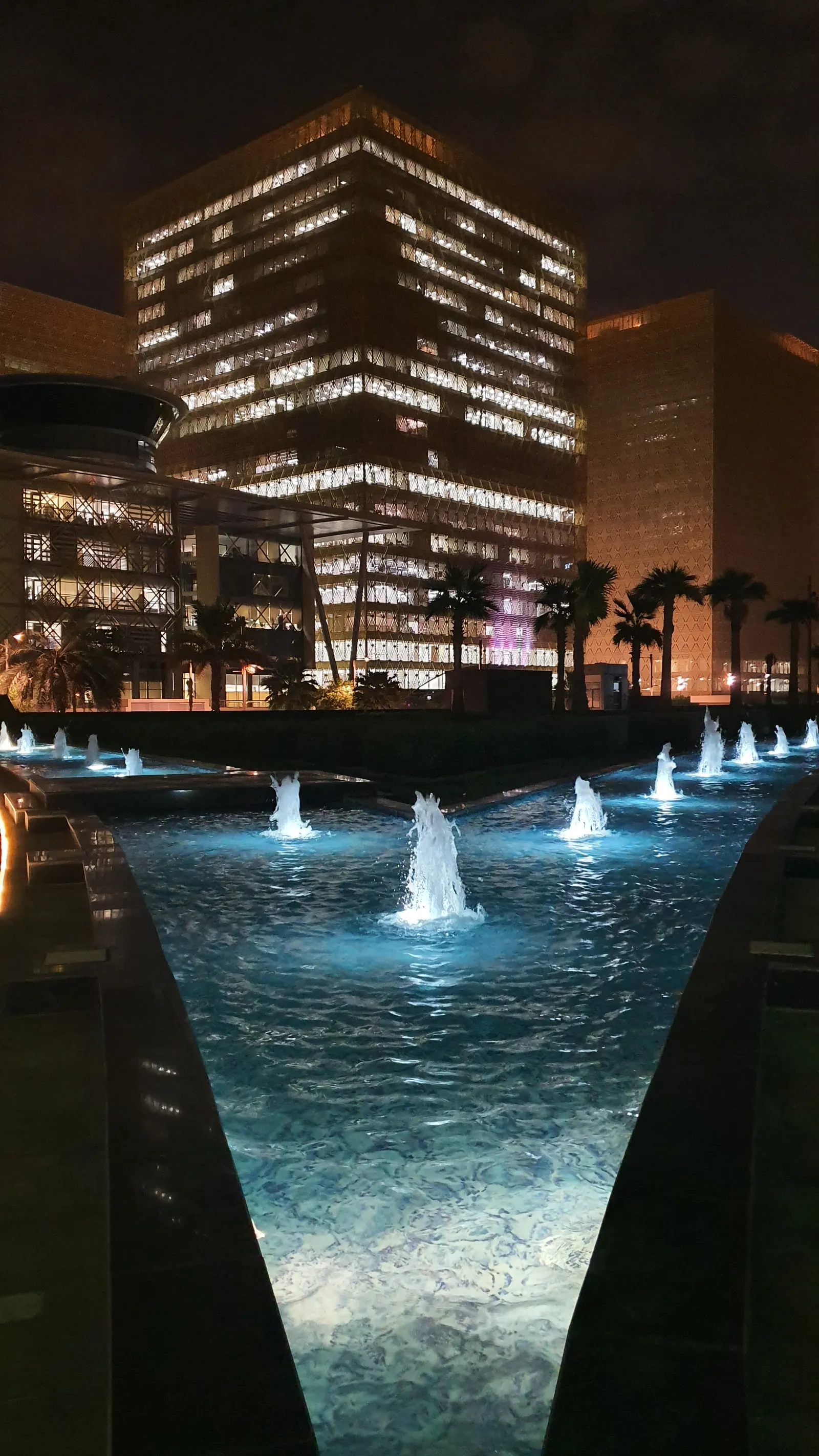 Long reflecting pool leading towards the city buildings