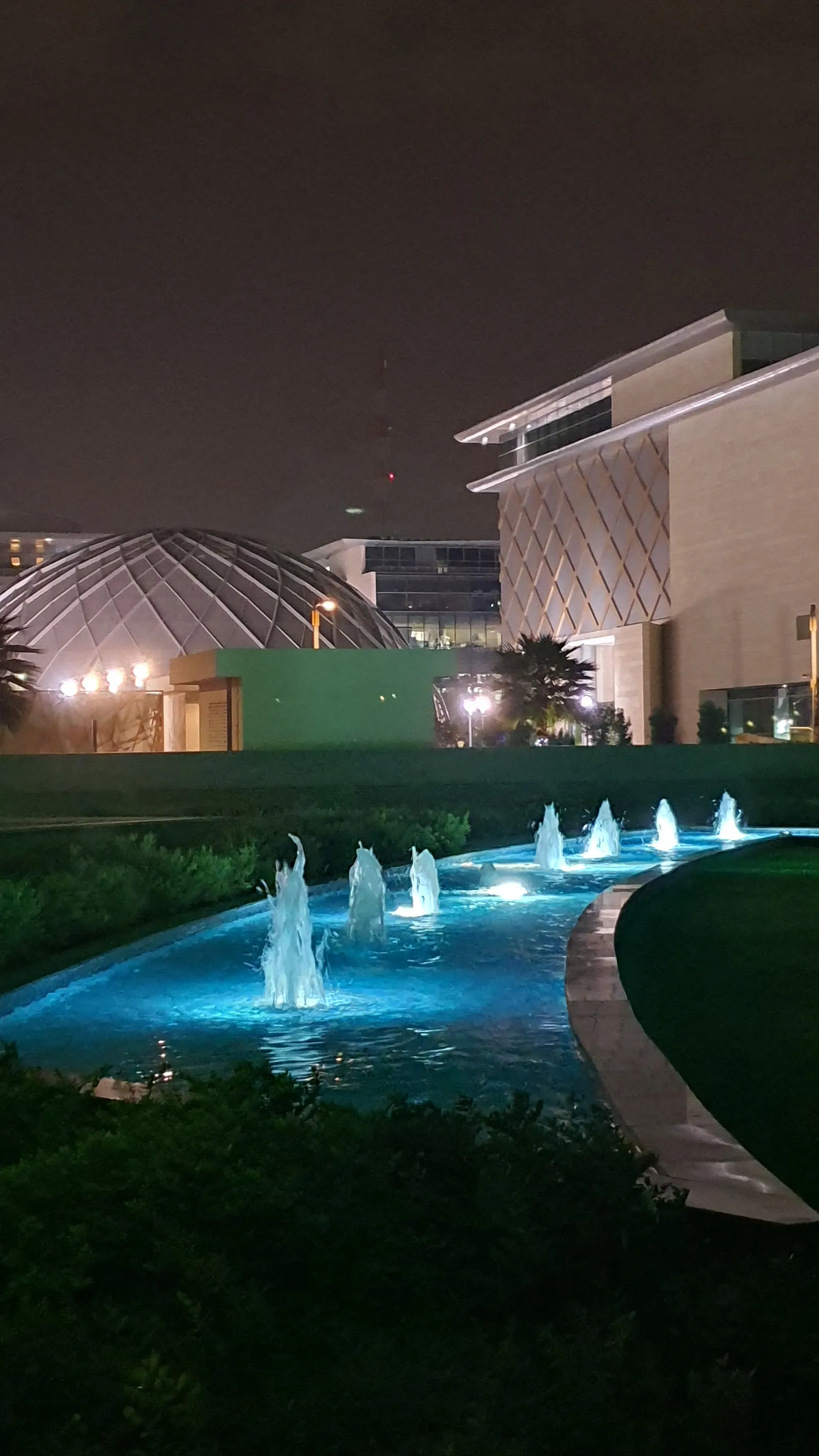 Water channel with fountains across the landscaped grounds