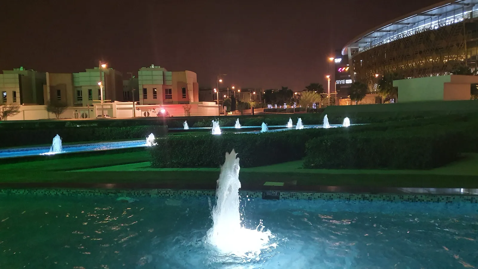 Vertical fountain jet lit against the night sky