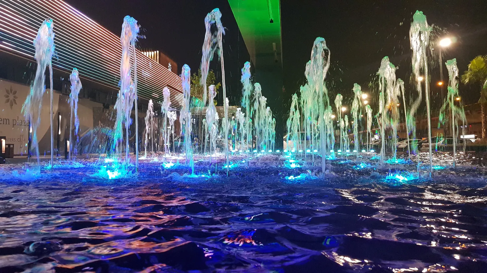Colour-changing fountain jets in front of the mall