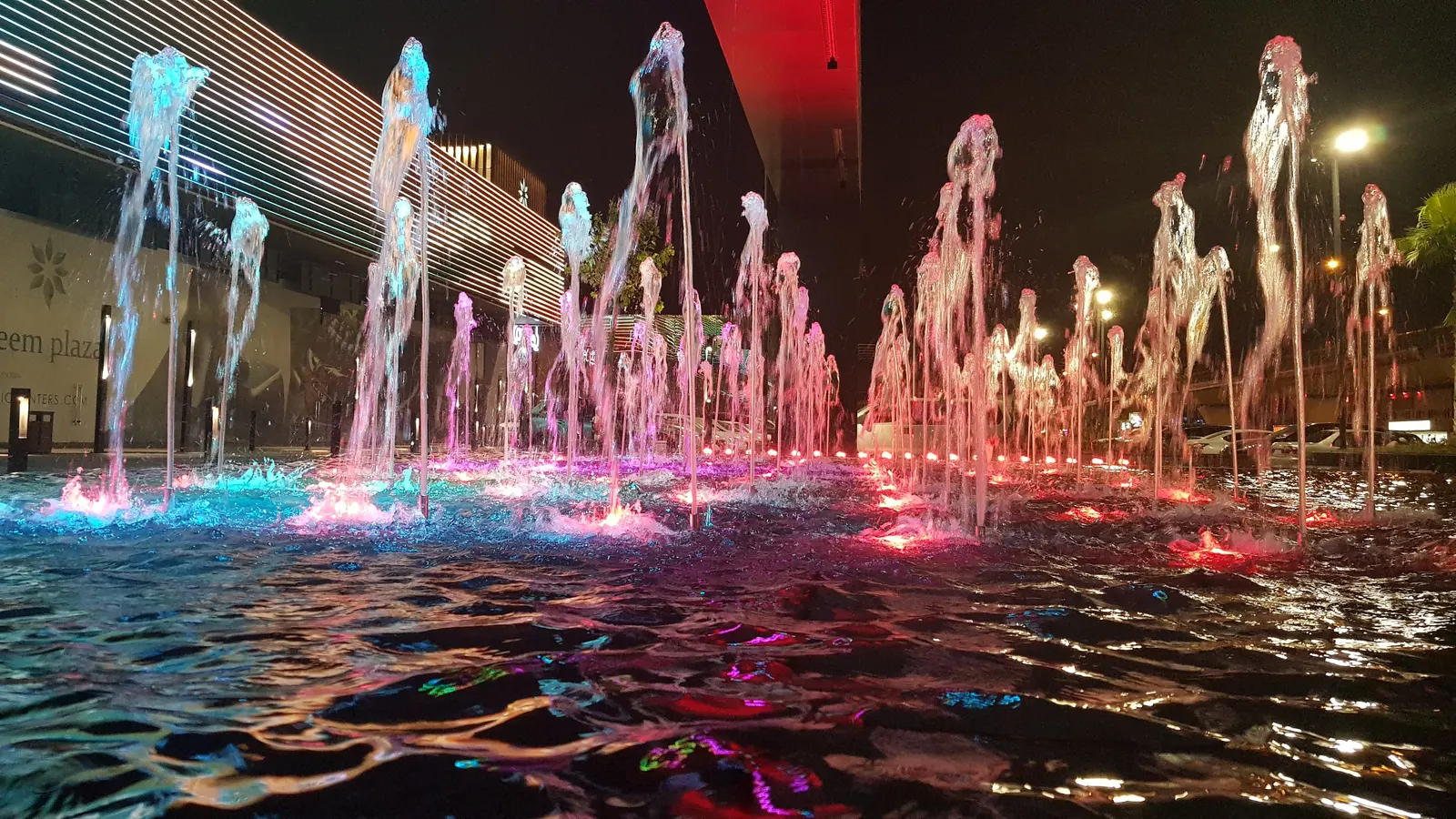 Fountain jets glowing green and red
