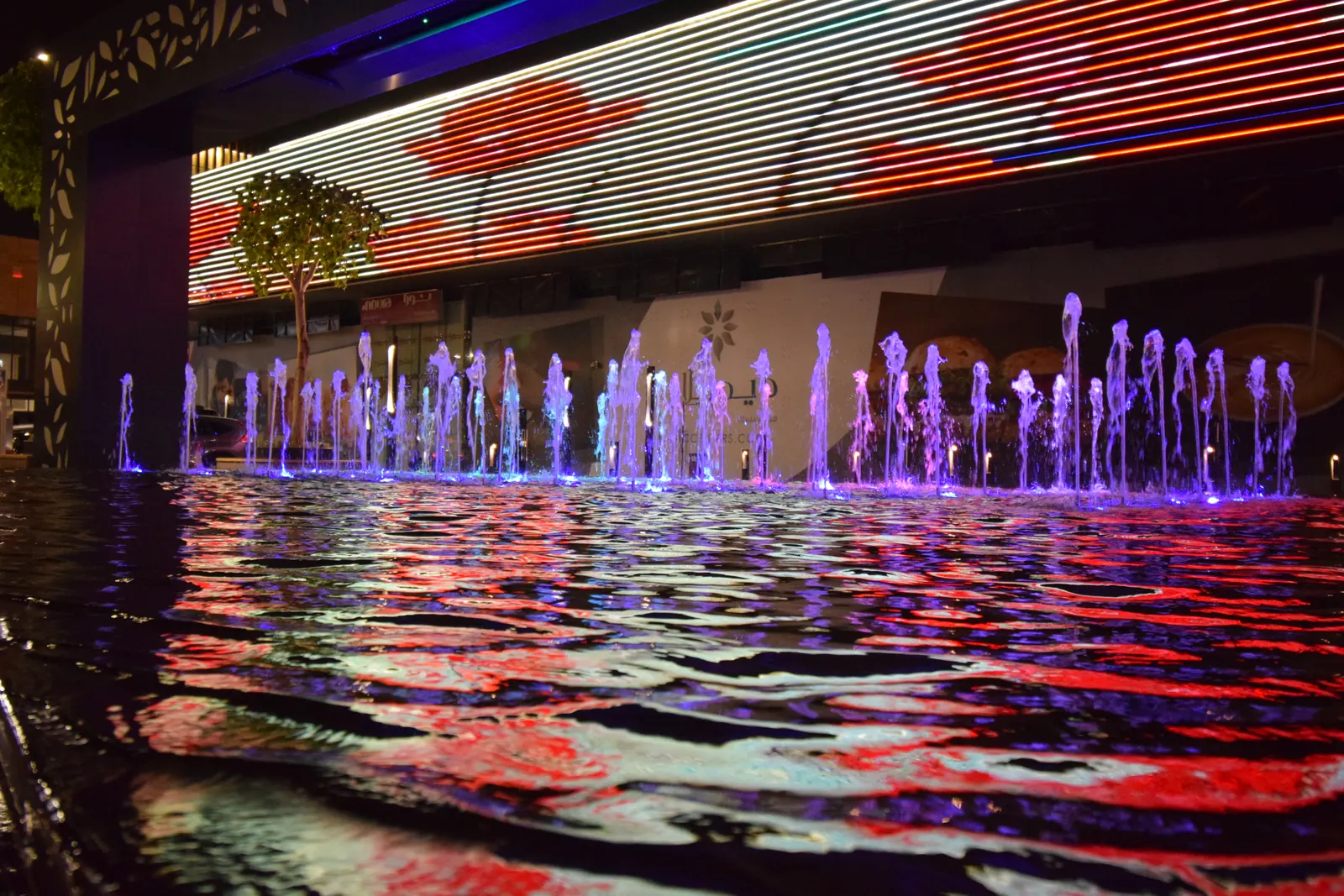 Fountain reflections on the pool at night