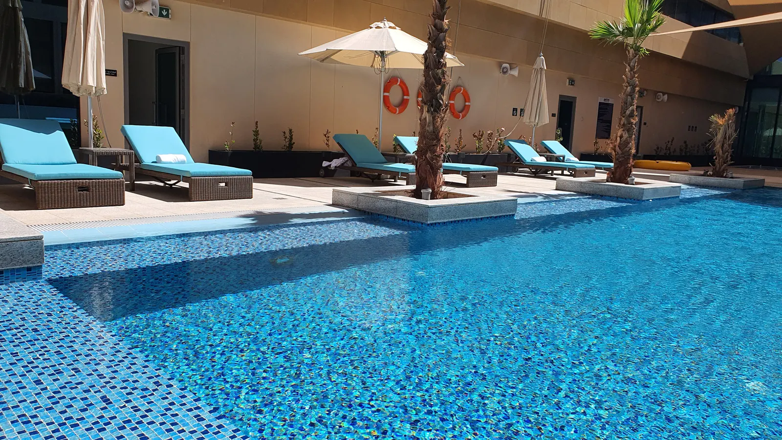 Pool deck with loungers and shade