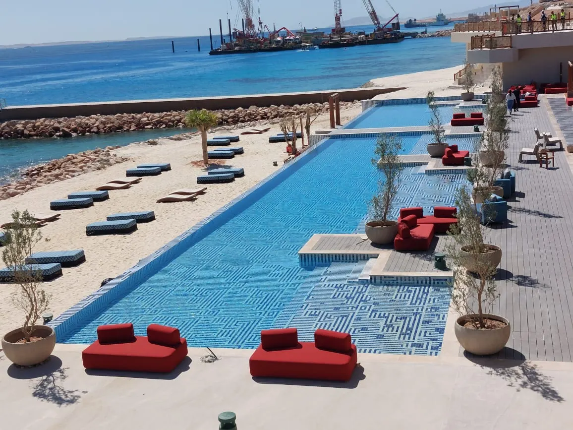 Pool deck with loungers beside the sea
