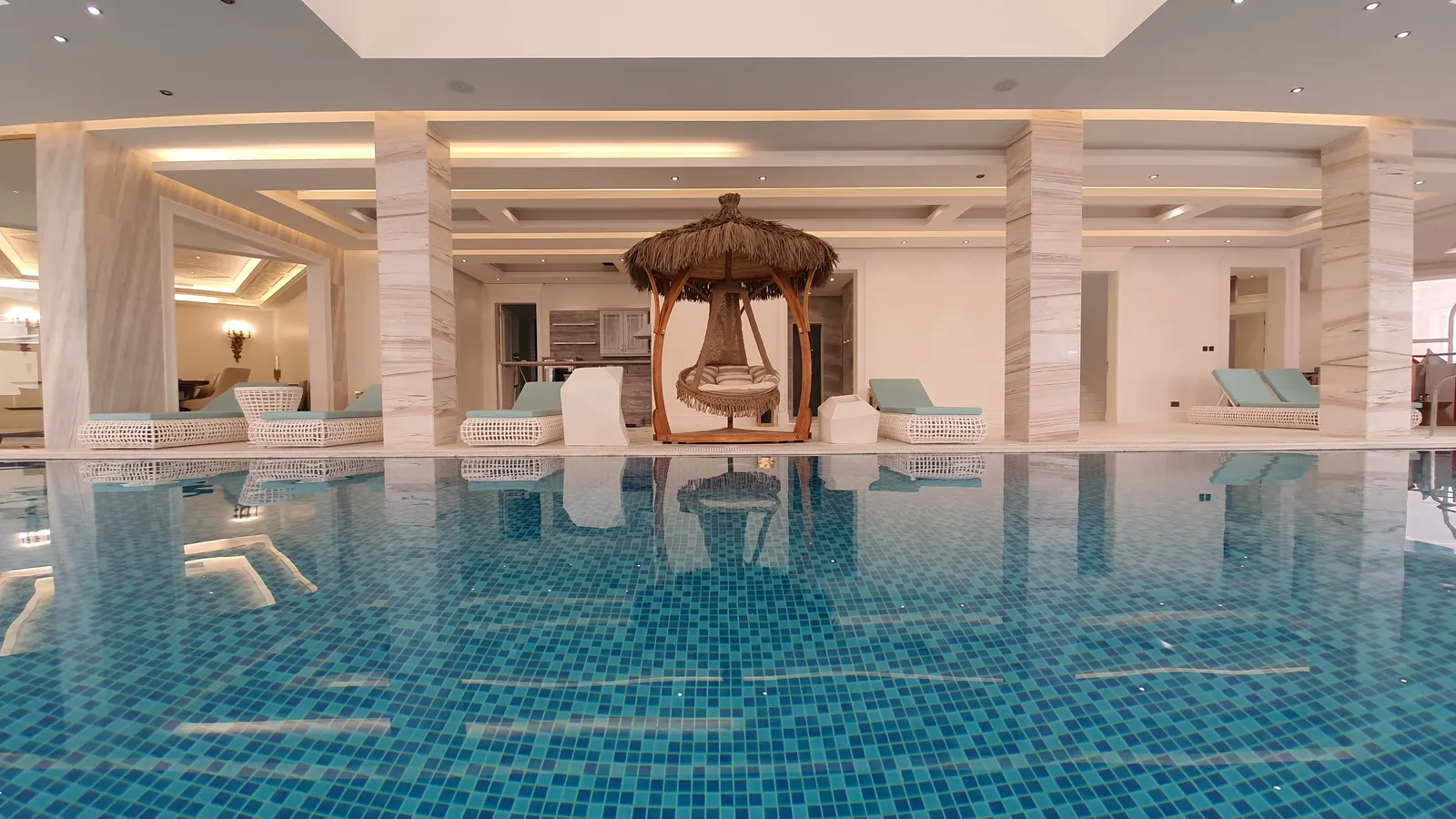 Indoor pool with a thatched cabana