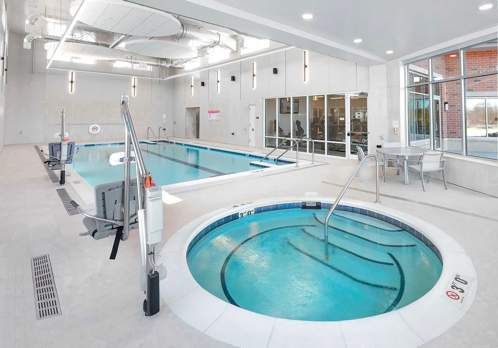 Hydrotherapy pool with a patient hoist at the edge