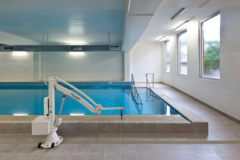 Rehabilitation pool with handrails and shallow steps